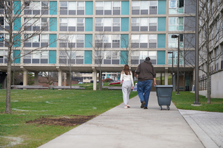 Nov. 15: Allison Boschetti (left) and her father Drew Boschetti walk back to Dellplain Hall to gather the last of her belongings before returning home for winter break. Students began moving out after SU announced that residential instruction would end on Nov. 12.